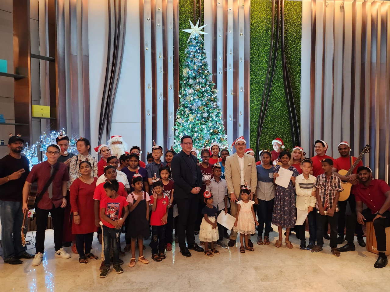 Guests pose for a picture at the Christmas tree lighting ceremony at the Amari Spice Penang. – Ian McIntyre pic