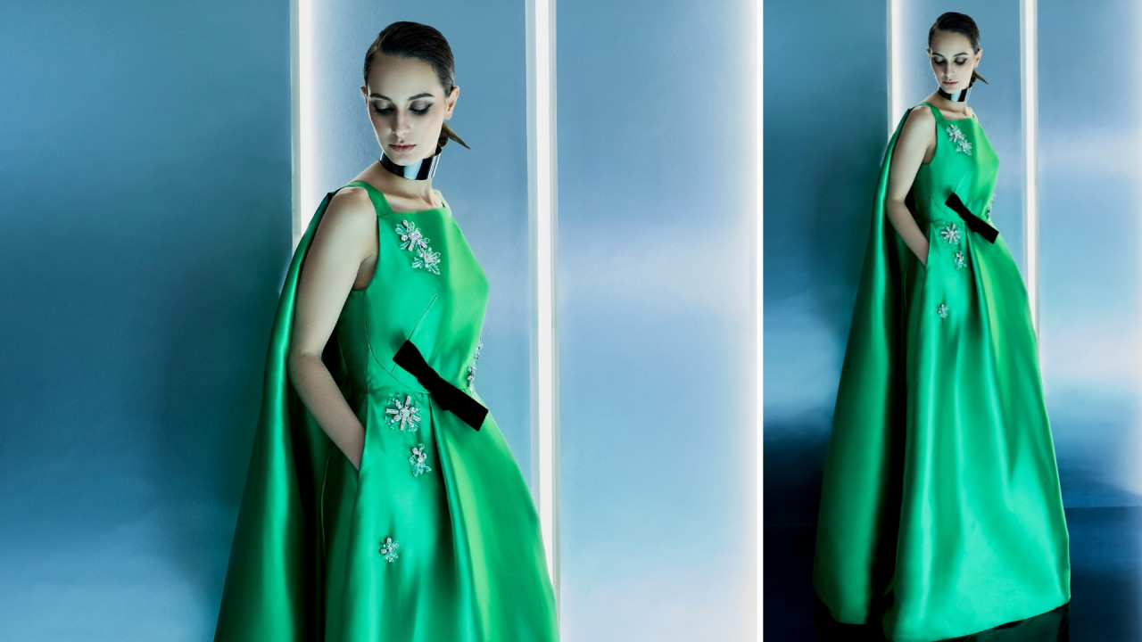 ‘Luna’. A striking sleeveless cape evening gown in glossy jade taffeta, highlighted with sparkling crystal embellishments and comet-like black bow pin. — Pic courtesy of Khoon Hooi