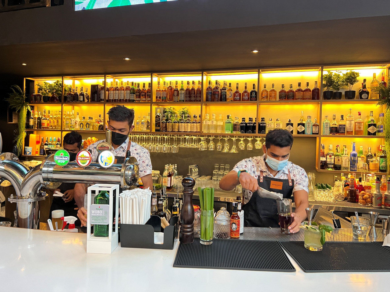 Bartenders hard at work crafting cocktails for customers. - Haikal Fernandez pic