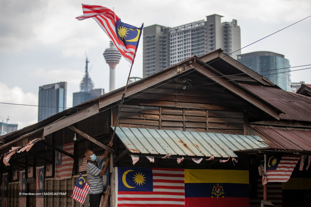 Rifa’i Jalinus, 71, put up about 50 Malaysian flags around his house in conjunction with the Malaysia Day celebration in Kg Baru, Kuala Lumpur. – SADIQ ASYRAF/The Vibes pic, September 16, 2021