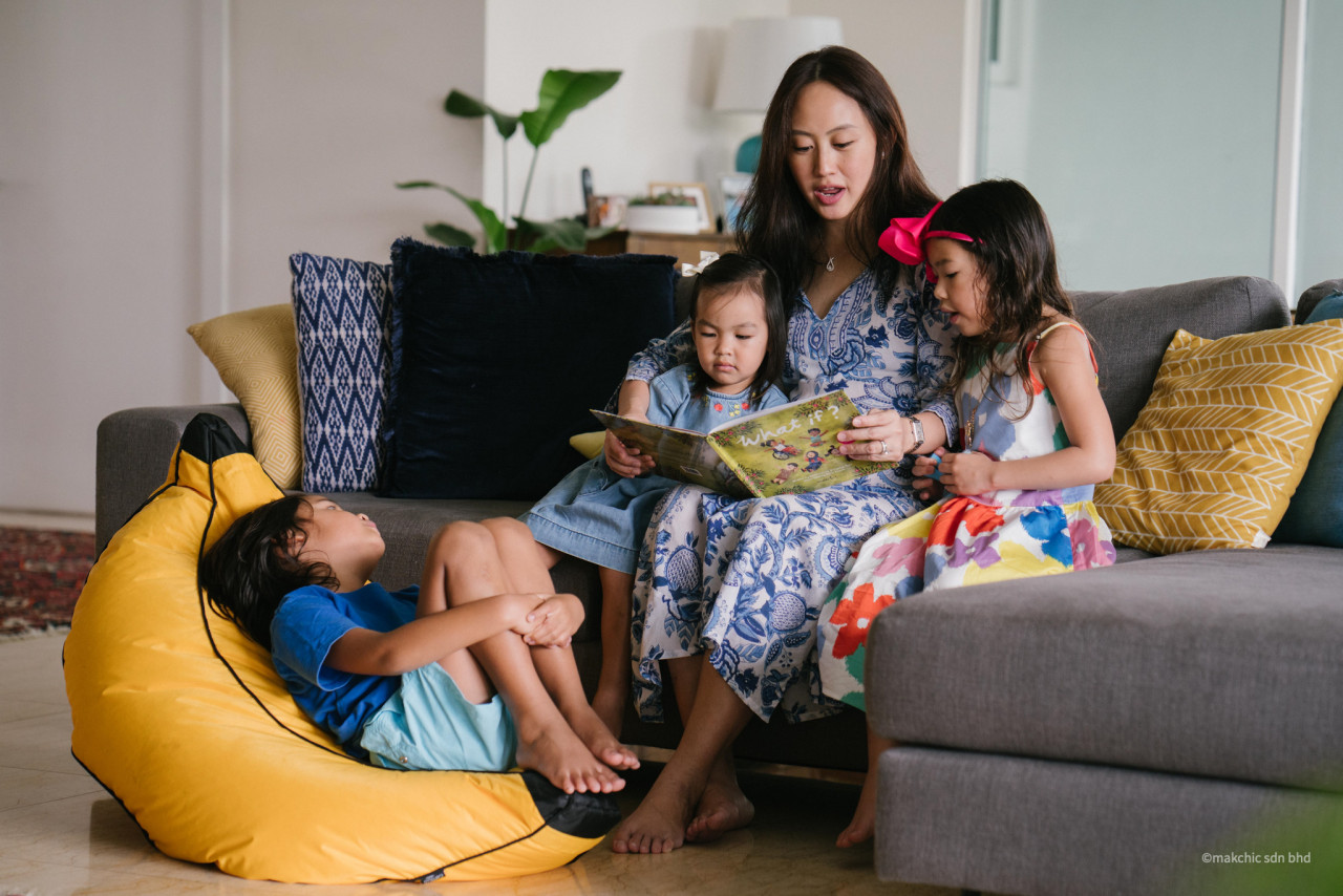 Liyana Taff, co-author of 'What If? by Makchic, reading to her children. – Pic courtesy of Makchic