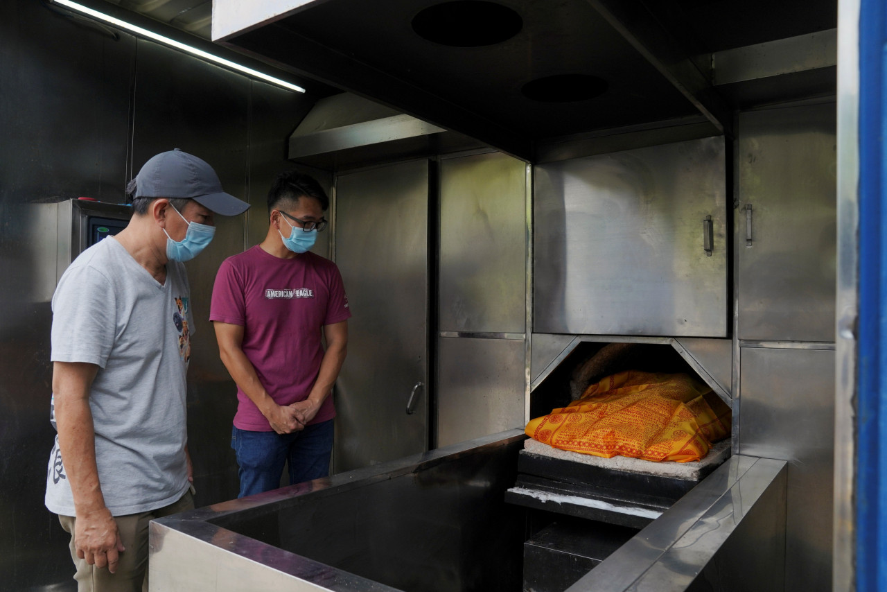 Kent Luk, founder of Paws Guardian Rescue Shelter, and James Chai, director of Rainbow Bridge Pet Cremation Services, bid farewell to the remains of stray animals during a cremation in Hong Kong, China, August 13. – Reuters pic
