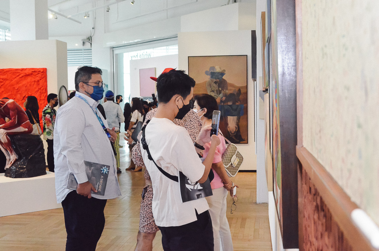 Visitors drink in the artwork during the launch event. – Pic courtesy of Segaris