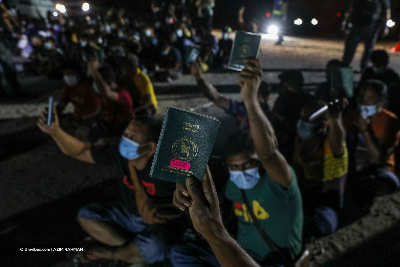 Migrants holding up their passports and identification documents. – AZIM RAHMAN/The Vibes pic, June 7, 2021