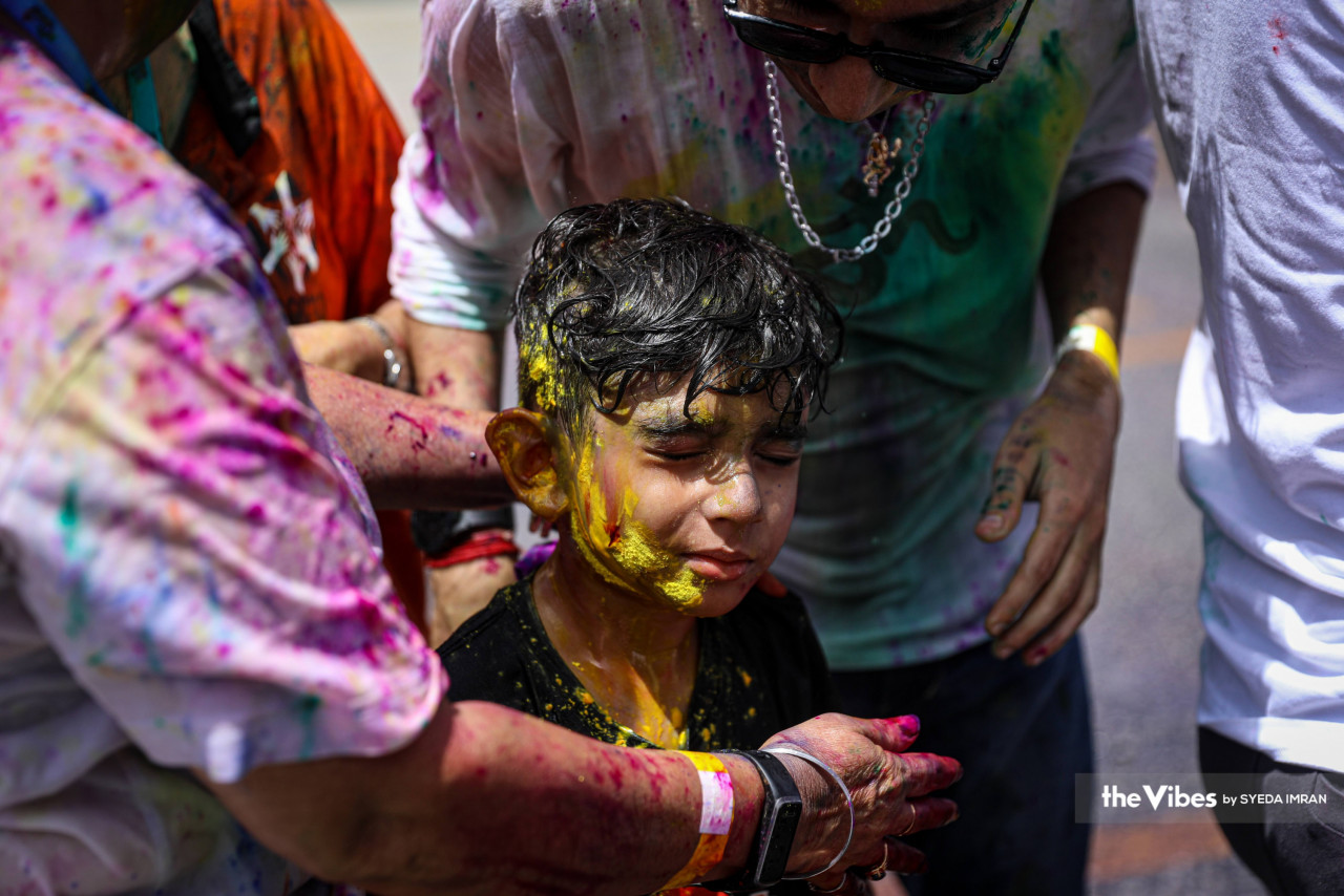 Bright as the sun, a striking streak of yellow covers nearly half of a boy’s face at the Holi festival last weekend. – SYEDA IMRAN/The Vibes pic, March 22, 2023