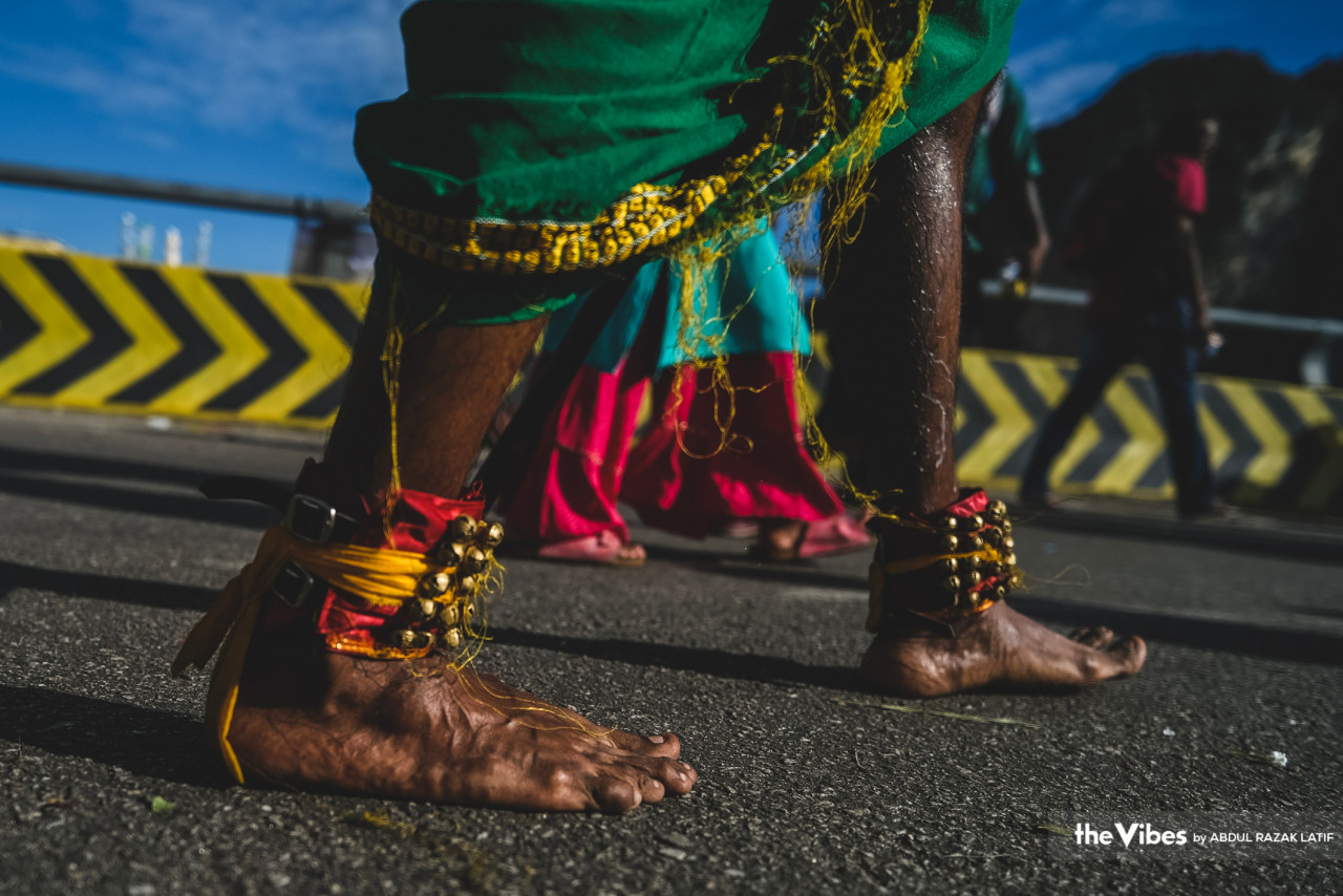 As the sun fully rises, devotees walk barefoot towards the temple at Batu Caves to pay homage to Lord Murugan, their ankles adorned with bells and colourful threads. – ABDUL RAZAK LATIF/The Vibes pic, February 6, 2023
