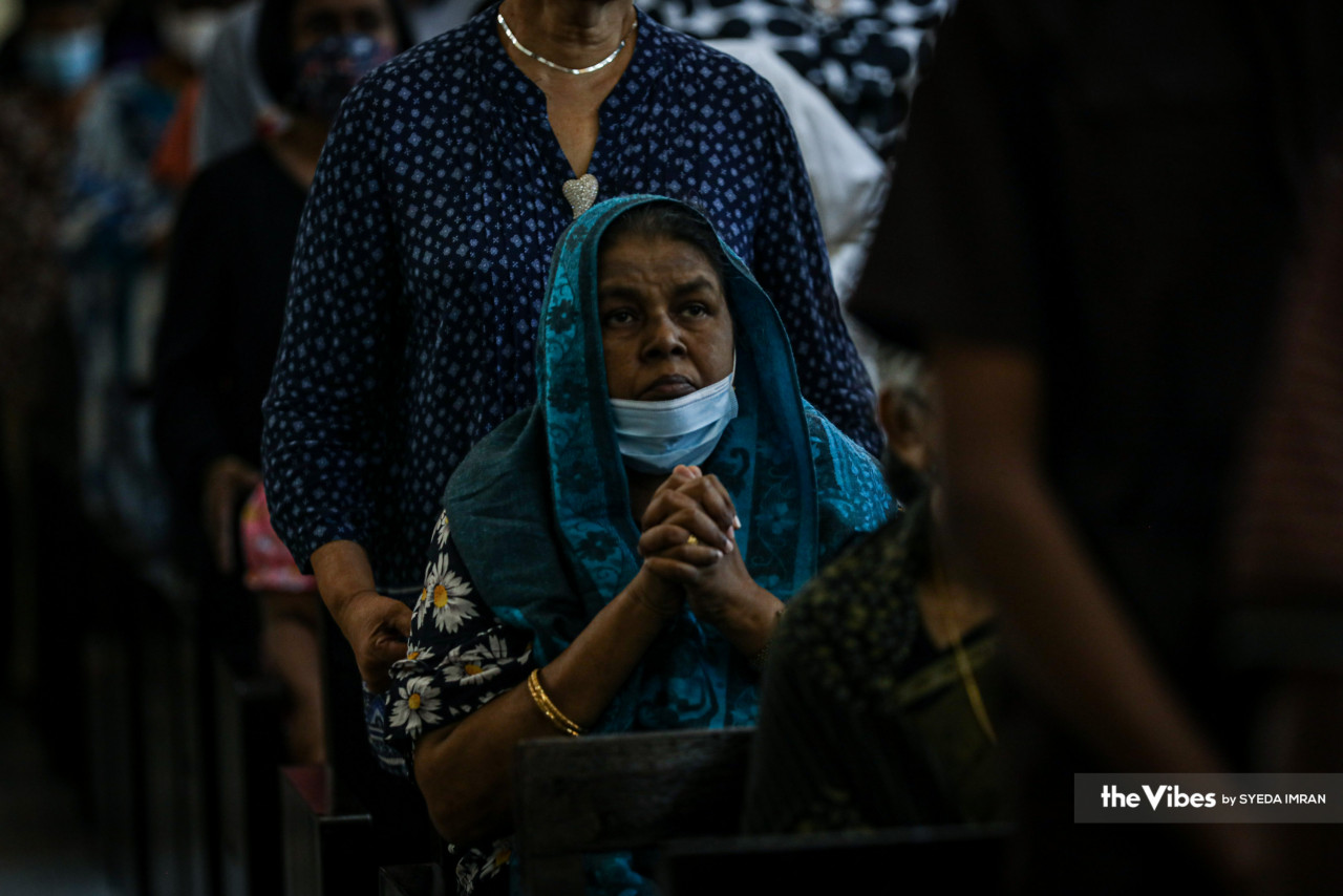 A woman, draped in a scarf, puts her hands together to pray in the Kuala Lumpur Tamil Methodist Church during yesterday’s Good Friday services. – SYEDA IMRAN/The Vibes, April 8, 2023