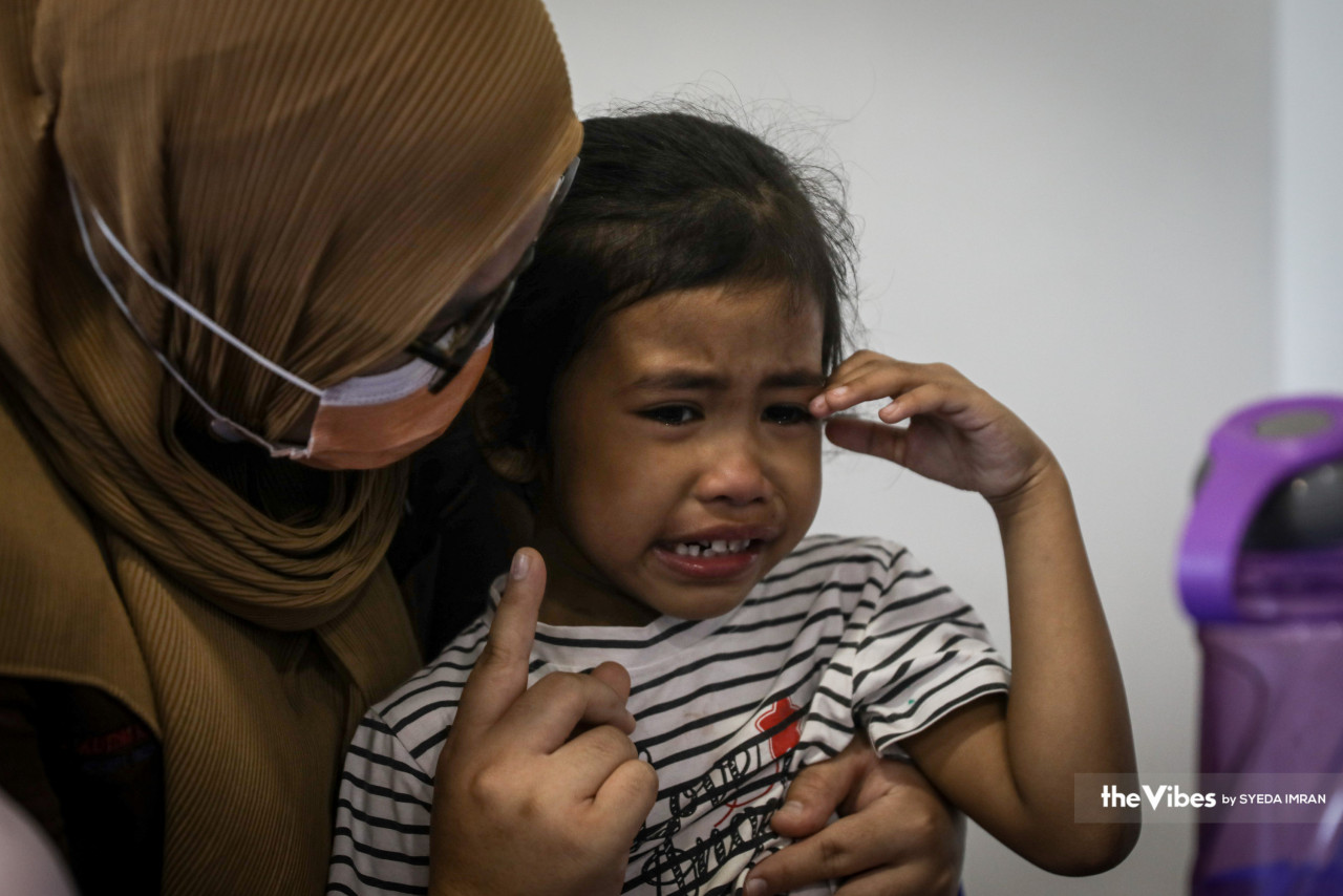 Dr Siti Shahiszma comforts and reasons with Nur Hayfa Hayra in the centre’s dining room as she cries because she did not get the food she wanted. – SYEDA IMRAN/The Vibes, April 2, 2023