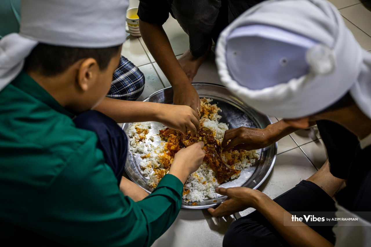 Tahfiz students break their fast, eating from a communal talam. – AZIM RAHMAN/The Vibes pic, April 9, 2023