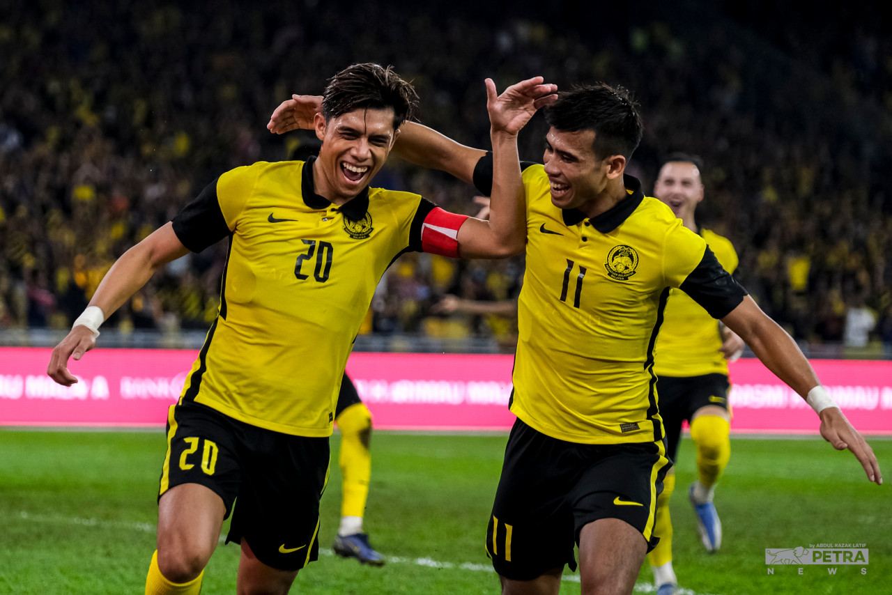 Muhammad Syafiq Ahmad (left) and Muhammad Safawi Rasid celebrate after the former gave Harimau Malaya a two-goal cushion in their 2023 Asian Cup qualifying clash at the Bukit Jalil National Stadium. – ABD RAZAK LATIF/The Vibes pic, June 14, 2022