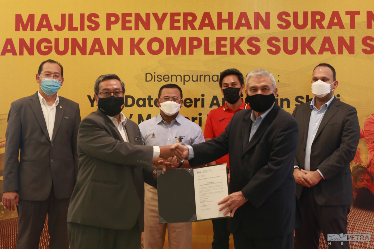 State secretary representing MBI Datuk Haris Kasim handing over a letter of intent to MRCB Executive Vice President Datuk Dell Akbar Khan for a detailed proposal on upgrading or redevelopment plans for the iconic Shah Alam Stadium. Looking on are (background from left): State Youth and Sports exco Mohd Khairuddin Othman; Selangor Menteri Besar Datuk Seri Amirudin Shari; Selangor FC CEO Dr Johan Kamal Hamidon (red t-shirt) and MRCB Group Managing Director Imran Salim. – NOOREEZA HASHIM/The Vibes pic, July 22, 2022