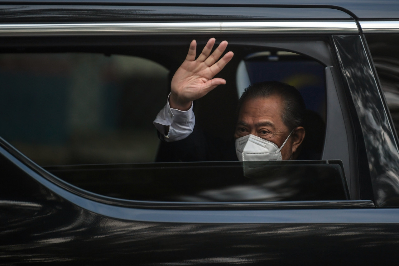 Prime Minister Tan Sri Muhyiddin Yassin waving to the press as he leaves his private residence in Bukit Damansara, Kuala Lumpur, early this morning. – Bernama pic, August 16, 2021 