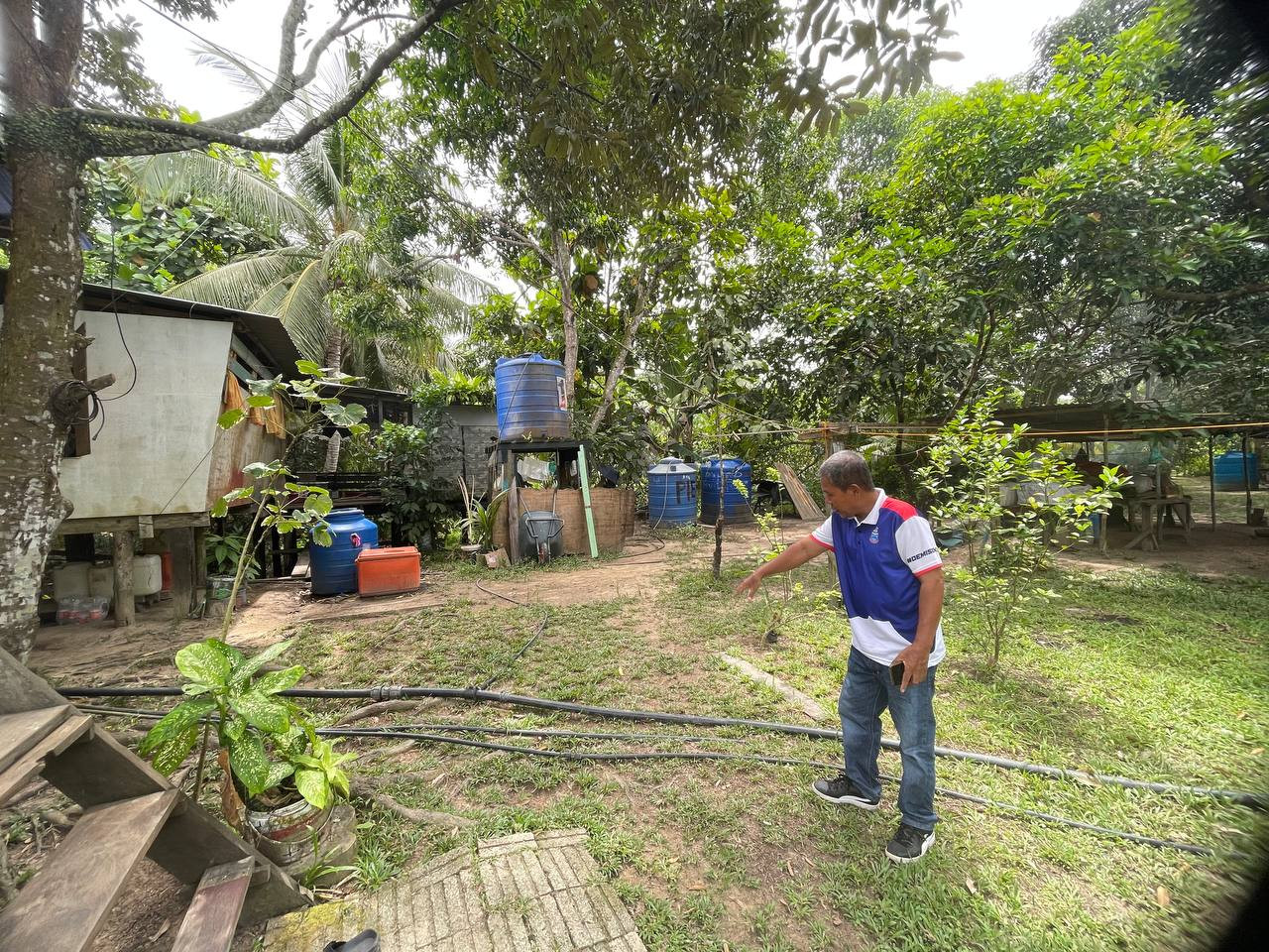 Kg Bambangan village chief Mahalan Yassin showing the water pipes set up by villagers 20 years ago to connect water from ponds in Kabili-Sepilok Forest Reserve to their homes. – REBECCA CHONG/The Vibes pic, August 21, 2022