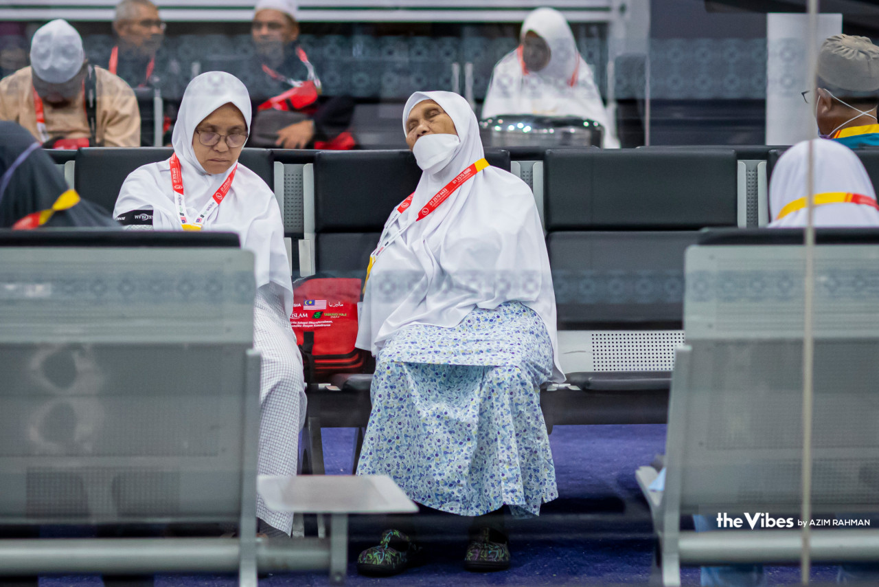 Haj pilgrims rest their eyes with a quick nap before boarding their 2.05am flight to Medina and beginning a long and spiritual journey. – AZIM RAHMAN/The Vibes pic, May 21, 2023