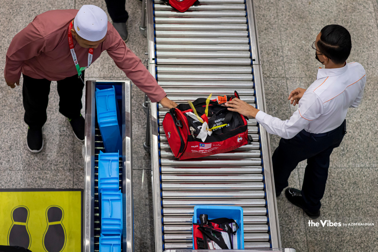 A traveller going through bag checks at KLIA before his flight to Medina. – AZIM RAHMAN/The Vibes pic, May 21, 2023