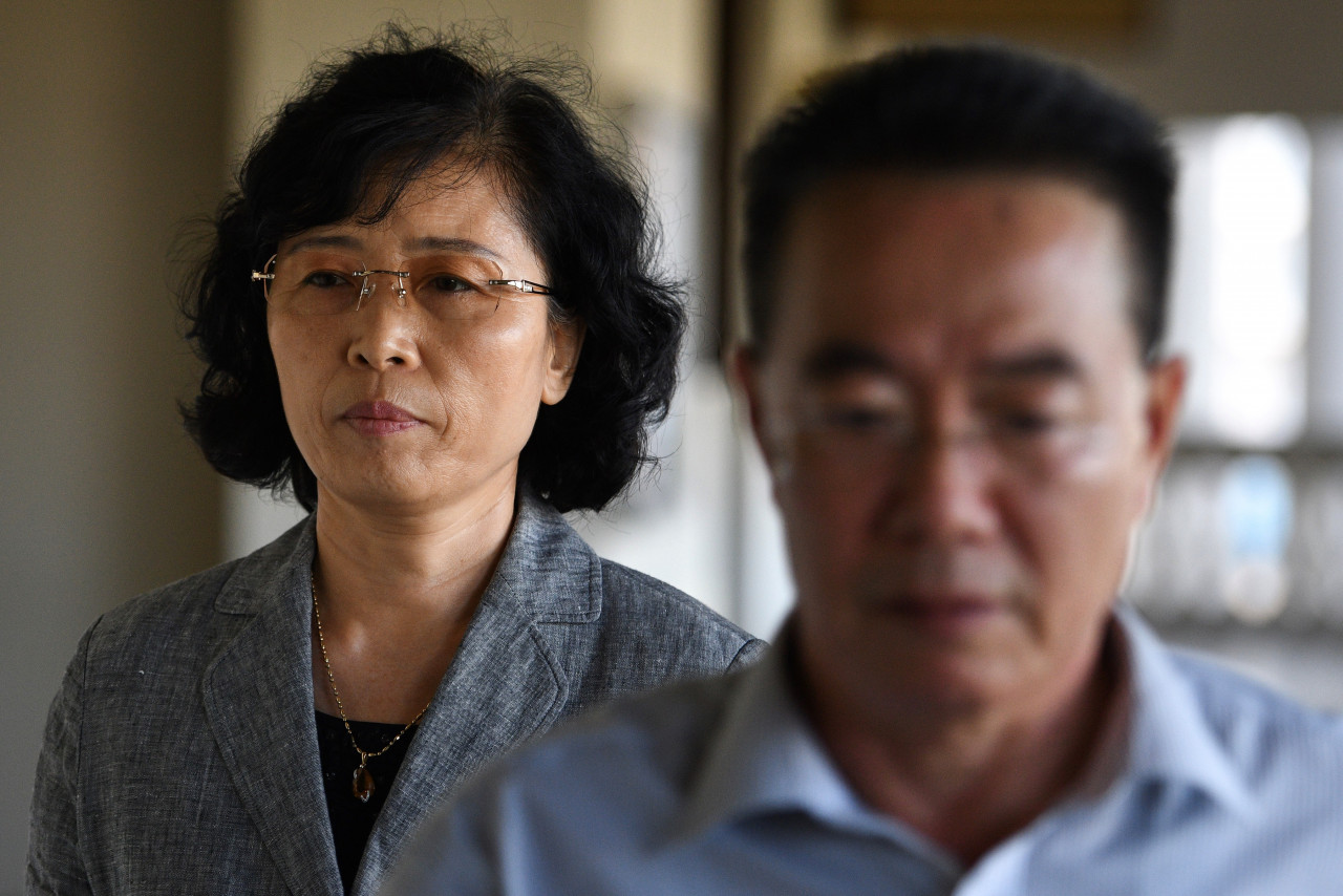 Kang Son-bi (left), the wife of Mun Chol-myong, and North Korean embassy counsellor Kim Yu-song at the Kuala Lumpur High Court in 2019. Mun, who was living in Malaysia with his family for a decade, was arrested in 2019 and faces four charges of money laundering and two of conspiracy to launder, mainly related to his work in Singapore. – AFP pic, March 20, 2021