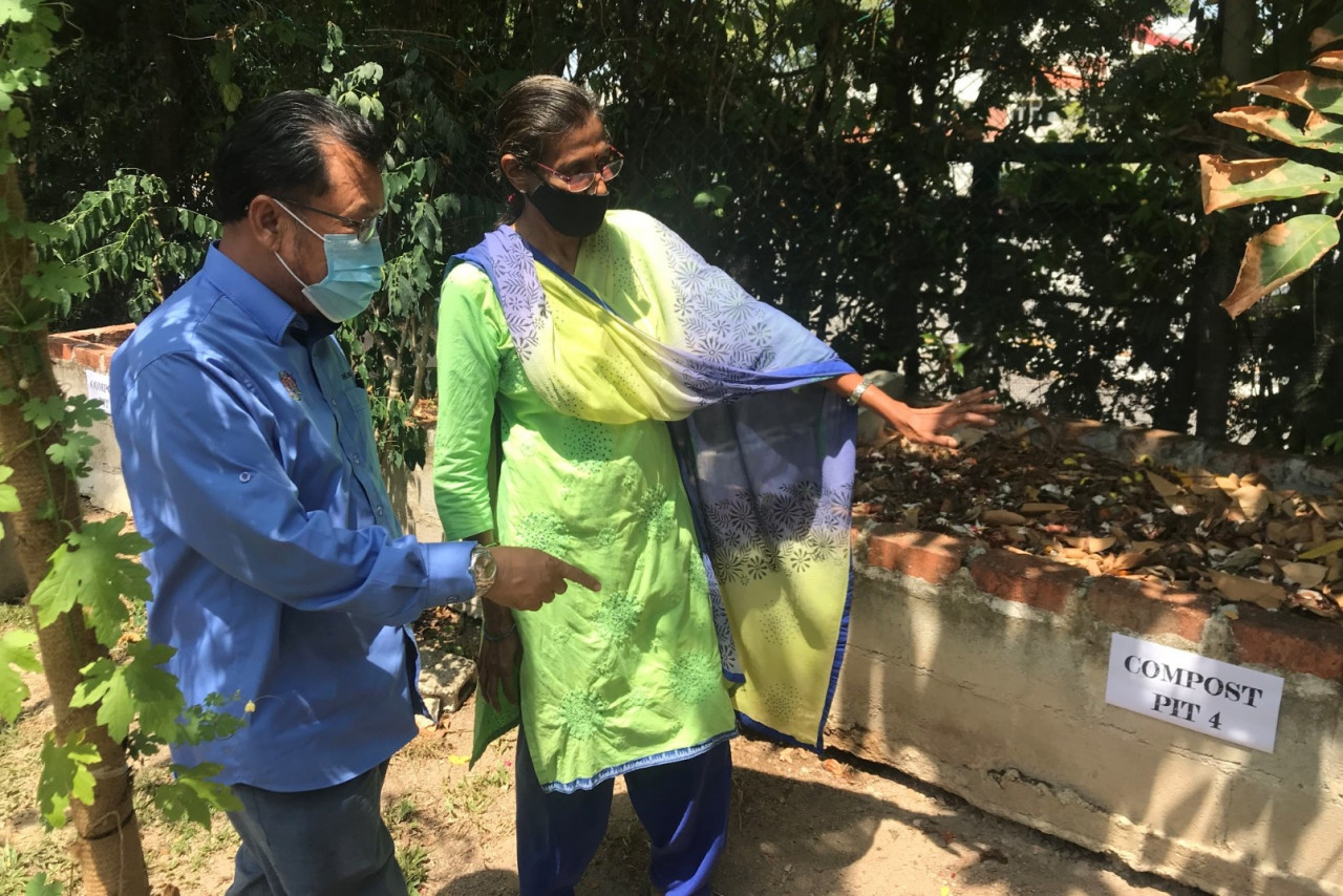 Deputy Agriculture and Food Industries Minister II Datuk Che Abdullah Mat Nawi and CAP education officer Saraswathi Devi Odian looking at compost pits at the association’s headquarters in Penang. – RACHEL YEOH/The Vibes pic, March 14, 2021
