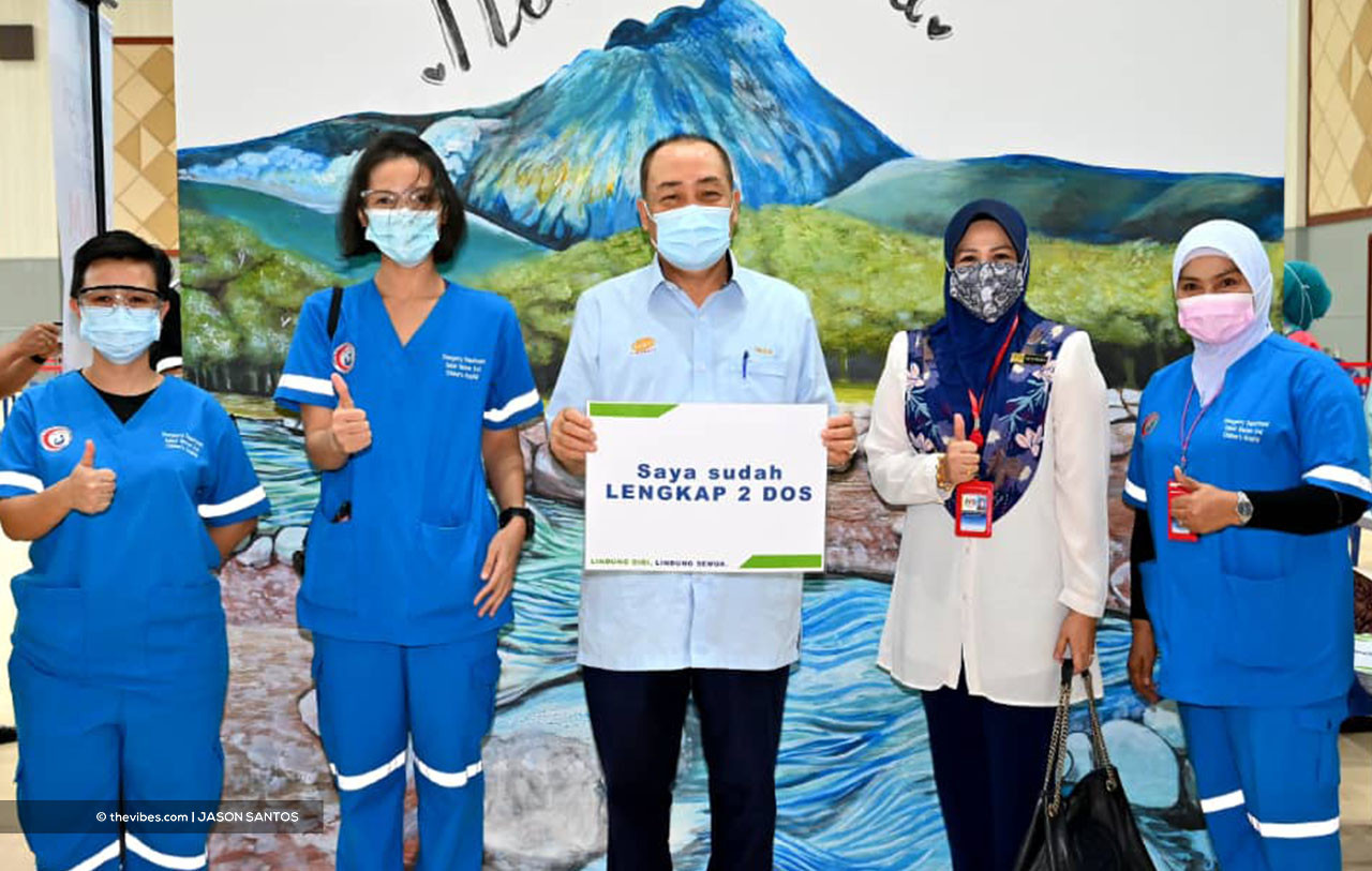Sabah Chief Minister Datuk Seri Hajiji Noor with frontliners holding a placard of proof after getting his second dose of the Covid-19 vaccine. Many Sabahans say they doubt that the Covid-19 vaccines are risk-free, and are worried about the possible side effects. – JASON SANTOS/The Vibes pic, April 9, 2021