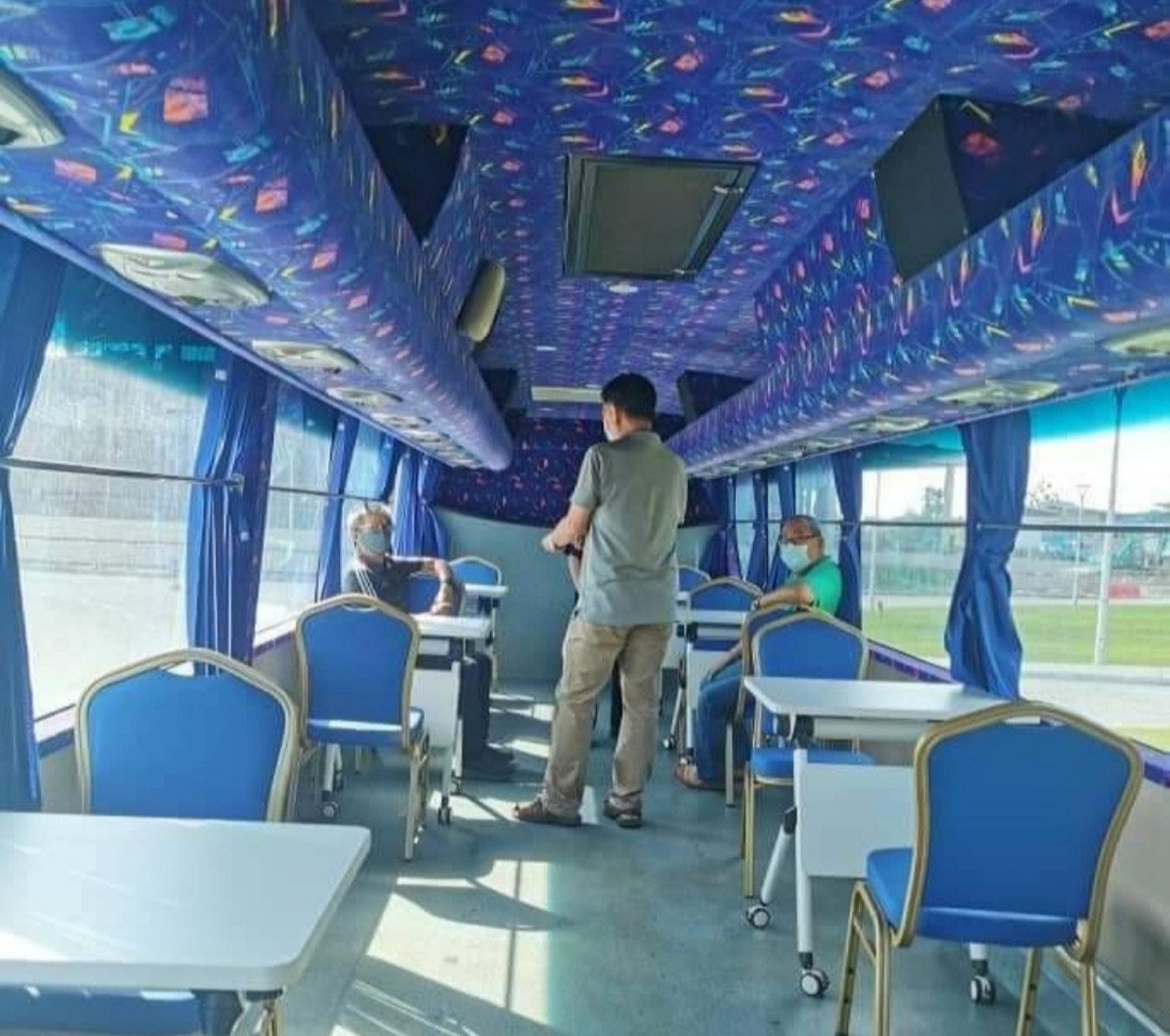 The interior of a UCT bus converted into a vaccination centre with tables and chairs. – Annuar Rapaee Facebook pic, June 30, 2021