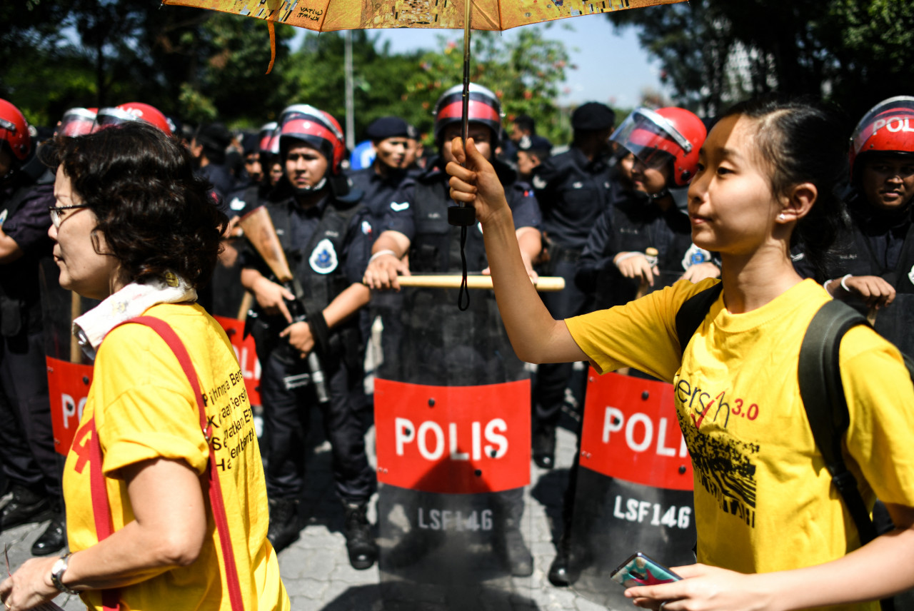 Protesters walk in front of the police force during a rally organised by Bersih 2.0 in Kuala Lumpur on March 28, 2018. – AFP pic, July 9, 2021