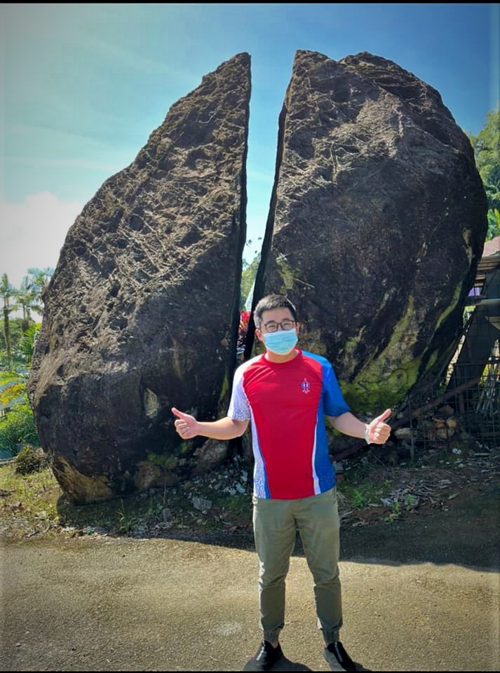 Stakan candidate Leslie Ting poses in front of Kg Quop’s iconic Batu Tepireh, or the 'Split Rock'. Ting is a familiar face in Kg Quop, a polling district in the Stakan constituency. – Leslie Ting Facebook pic, December 17, 2021