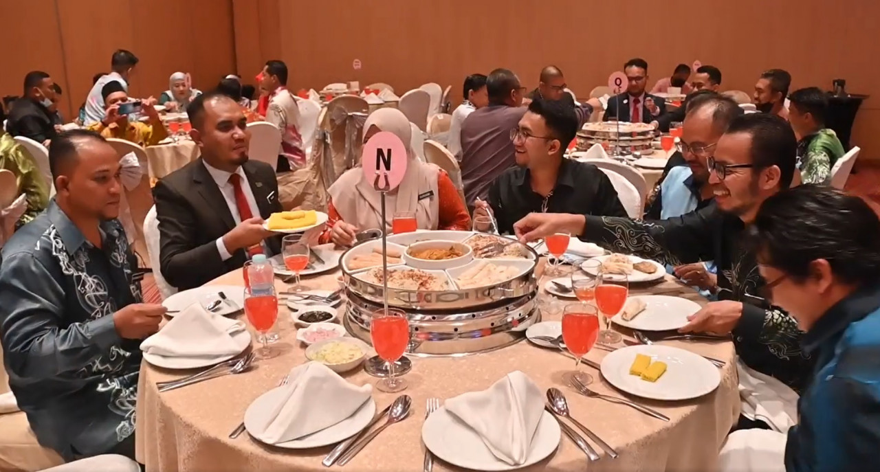 Civil servants feted at the Excellent Service Award 2021 ceremony enjoy a feast prepared for them at the Spice Arena yesterday. – Screen grab pic, June 8, 2022