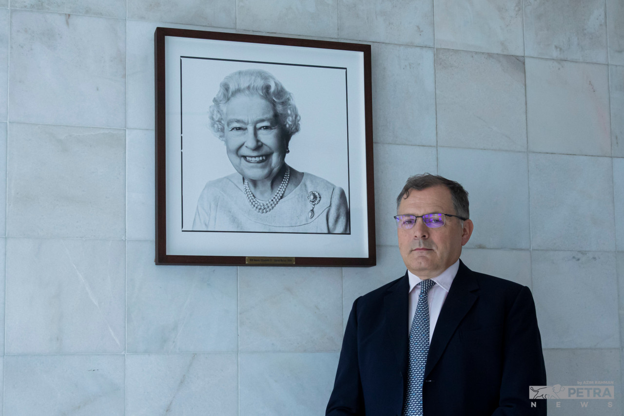 British High Commissioner to Malaysia, Charles Hay, poses for a photo with a portrait of the late Queen Elizabeth II at his residence in Kuala Lumpur. He says the question on whether the United Kingdom should continue to be ruled by a hereditary monarch is ‘perfectly legitimate’. – AZIM RAHMAN/The Vibes pic, October 2, 2022