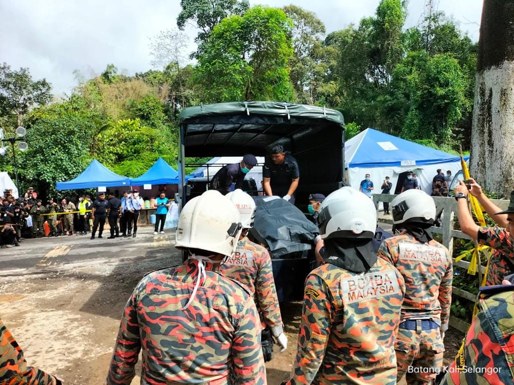 Rescuers at Batang Kali carry one of the bodies found today into a truck. The Fire and Rescue Department says the four bodies found today were recovered in Sector C (Riverside) of the search area. – Korporat JBPM Facebook pic, December 22, 2022
