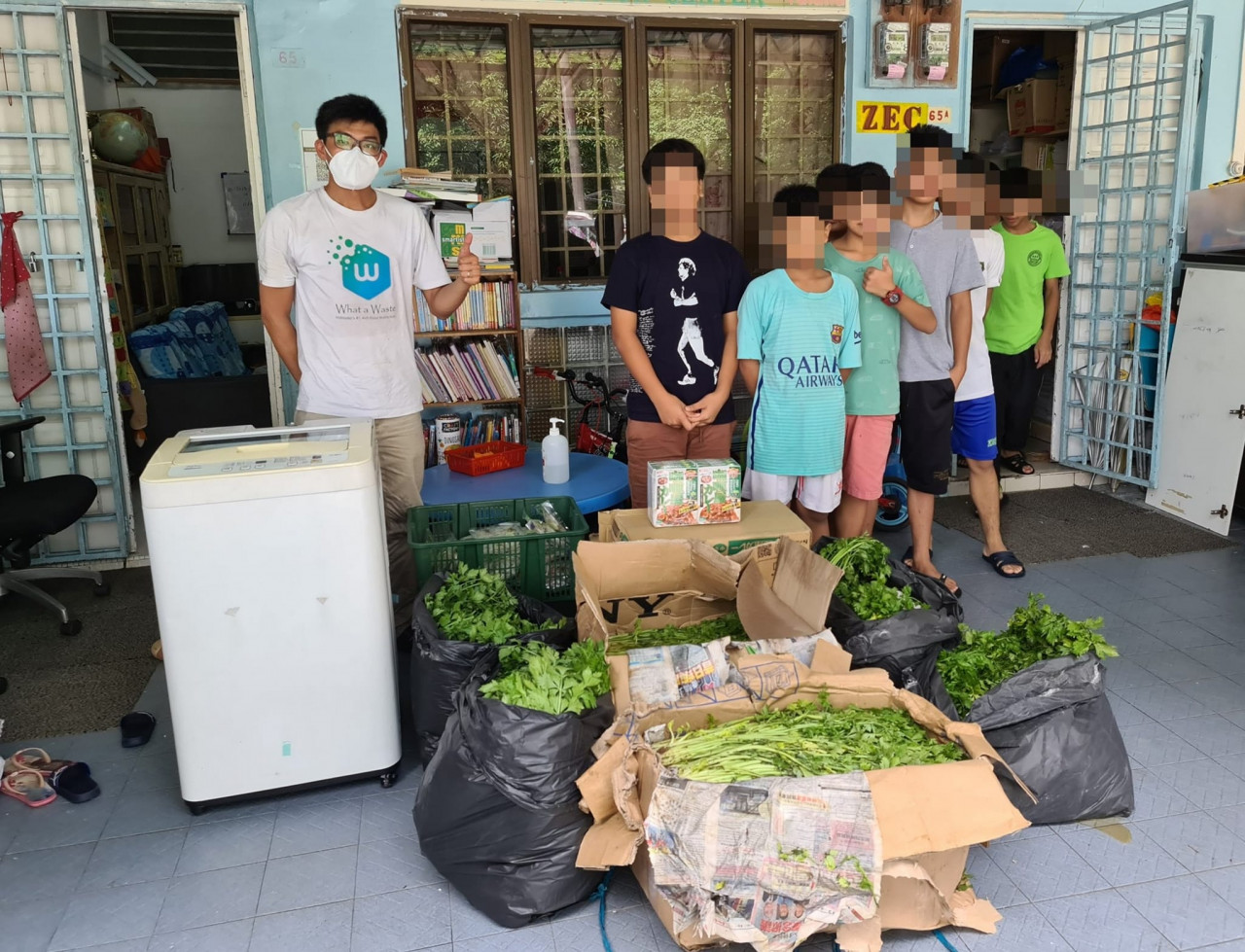 What a Waste co-founder Alvin Chen (left) poses for a photo with recipients of food aid from the movement. – What A Waste Facebook pic, January 22, 2023