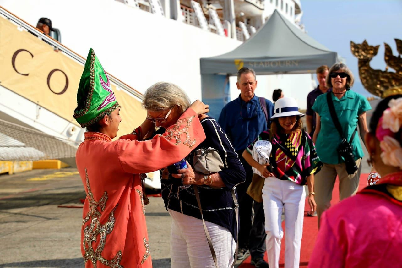 A man dressed in a traditional costume welcomes passengers onboard the Seaborn Encore as they arrive in Kota Kinabalu today. – Pic courtesy of Sabah Tourism Board, February 15, 2023 