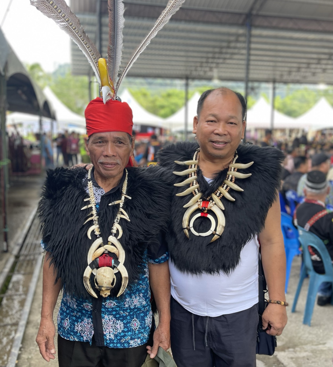 Two Murut men from the Okolod sub-ethnic group in Sarawak wear traditional fur coats and necklaces adorned with what appear to be wild boar fangs. – JASON SANTOS/The Vibes pic, July 26, 2023 