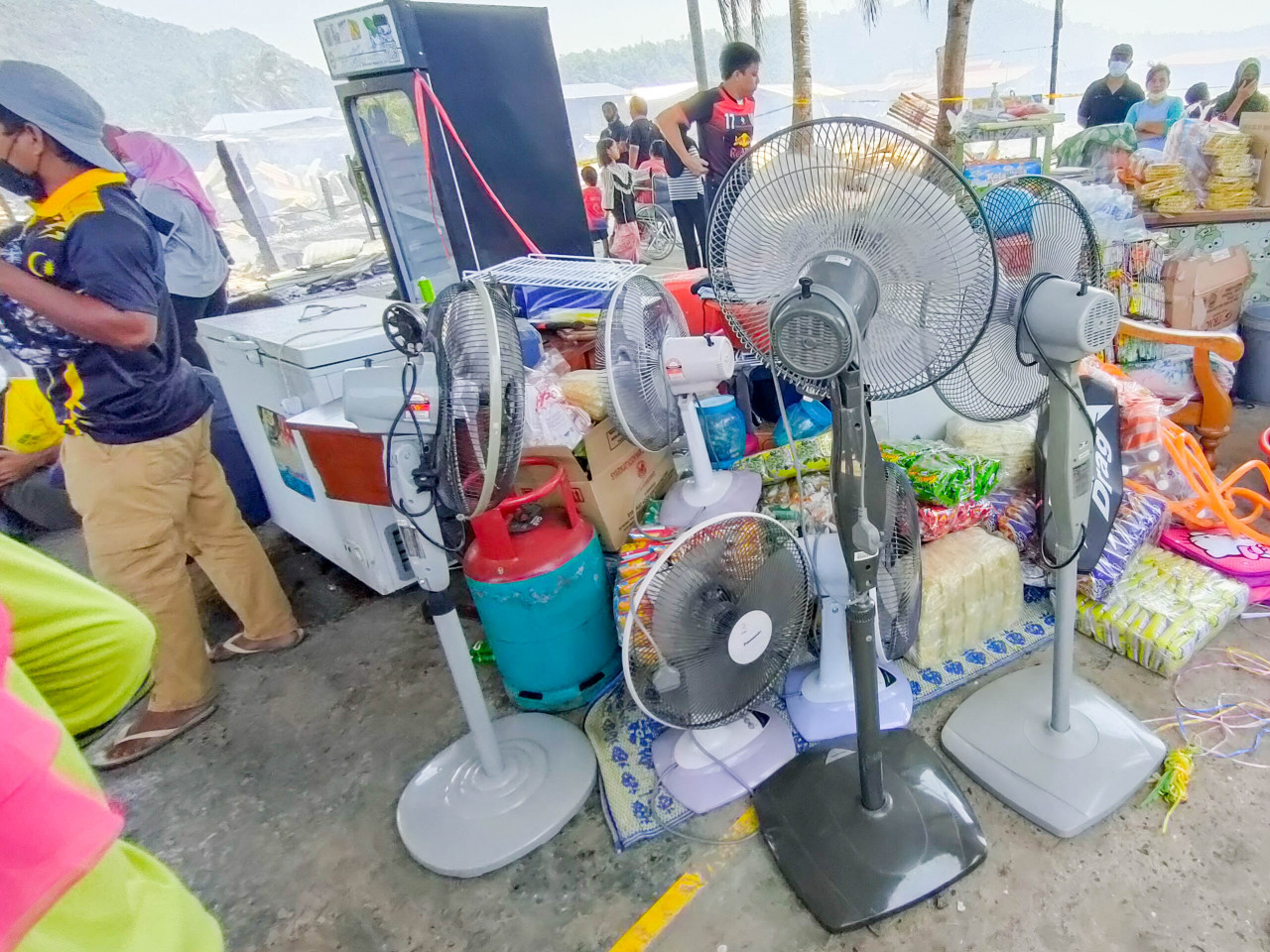 Stand fans are among items that victims saved before their houses were destroyed by the fire this morning. – The Vibes pic, April 21, 2021