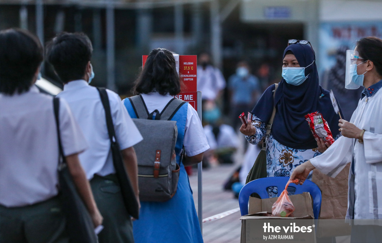 Students wearing masks were already lining up to have their temperatures taken at schools from as early as 6.30am. – AZIM RAHMAN/The Vibes pic, February 22, 2021