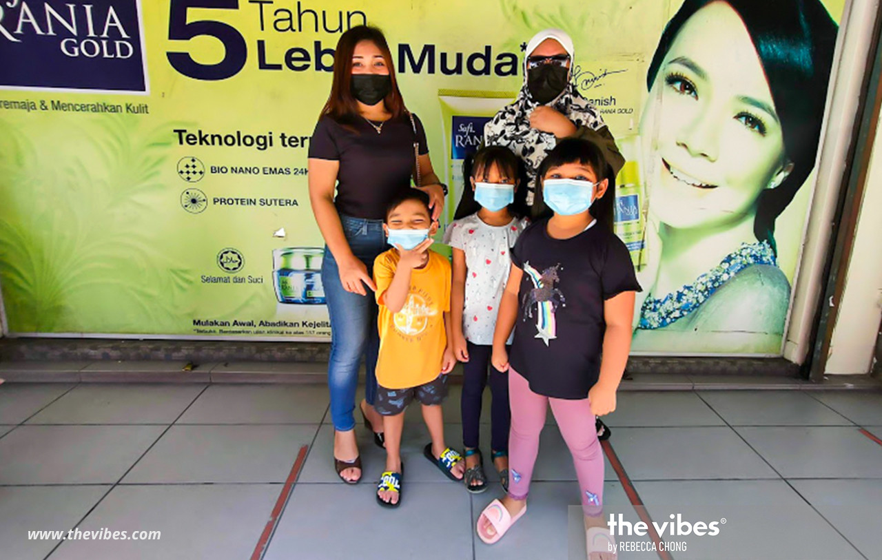 Azila Alawi (left) brought her family shopping today as it is her first day-off from work after receiving her salary. – REBECCA CHONG/The Vibes pic, February 28, 2021