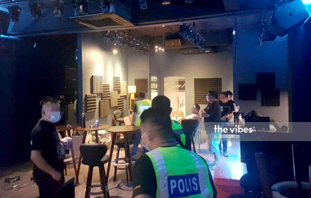 Police raiding a pub in Bandar Indah, Sandakan, last September. Five men and 10 women were fined for breaching virus SOPs. – The Vibes file pic, March 21, 2021