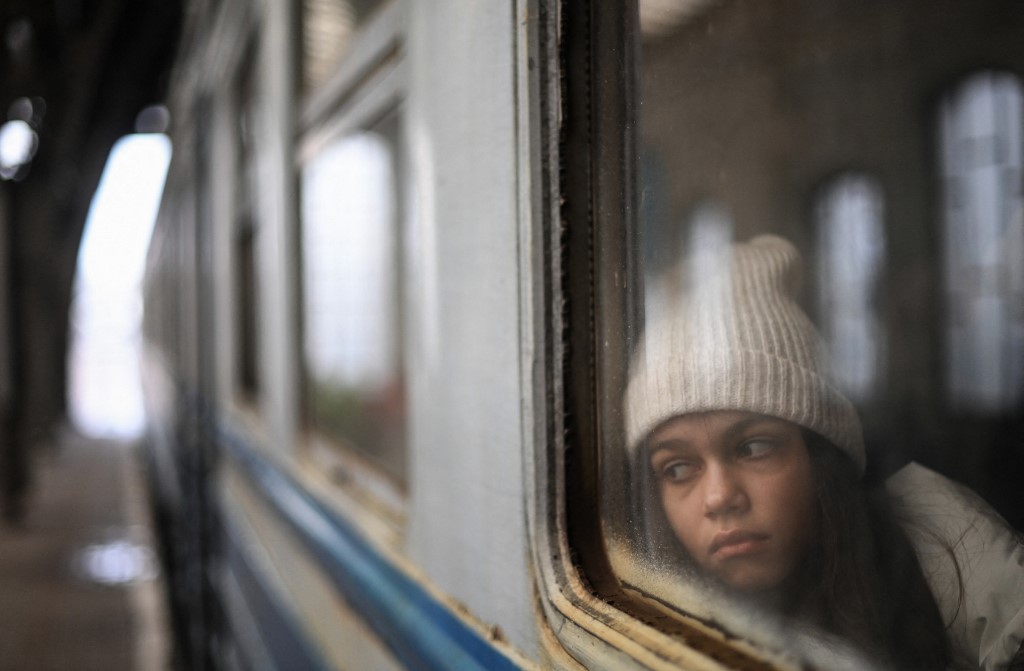A girl looks out from a window as she waits inside a train taking refugees to Poland at Lviv train station, western Ukraine, on Saturday. – AFP pic, March 7, 2022