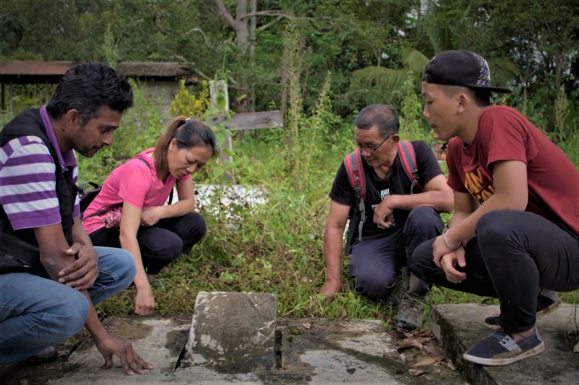 Candidate Agnes Padan and her family visit the cemetery of her mother Kam Agong, who had passed away due to medical negligence. – Screen grab, December 12, 2021
