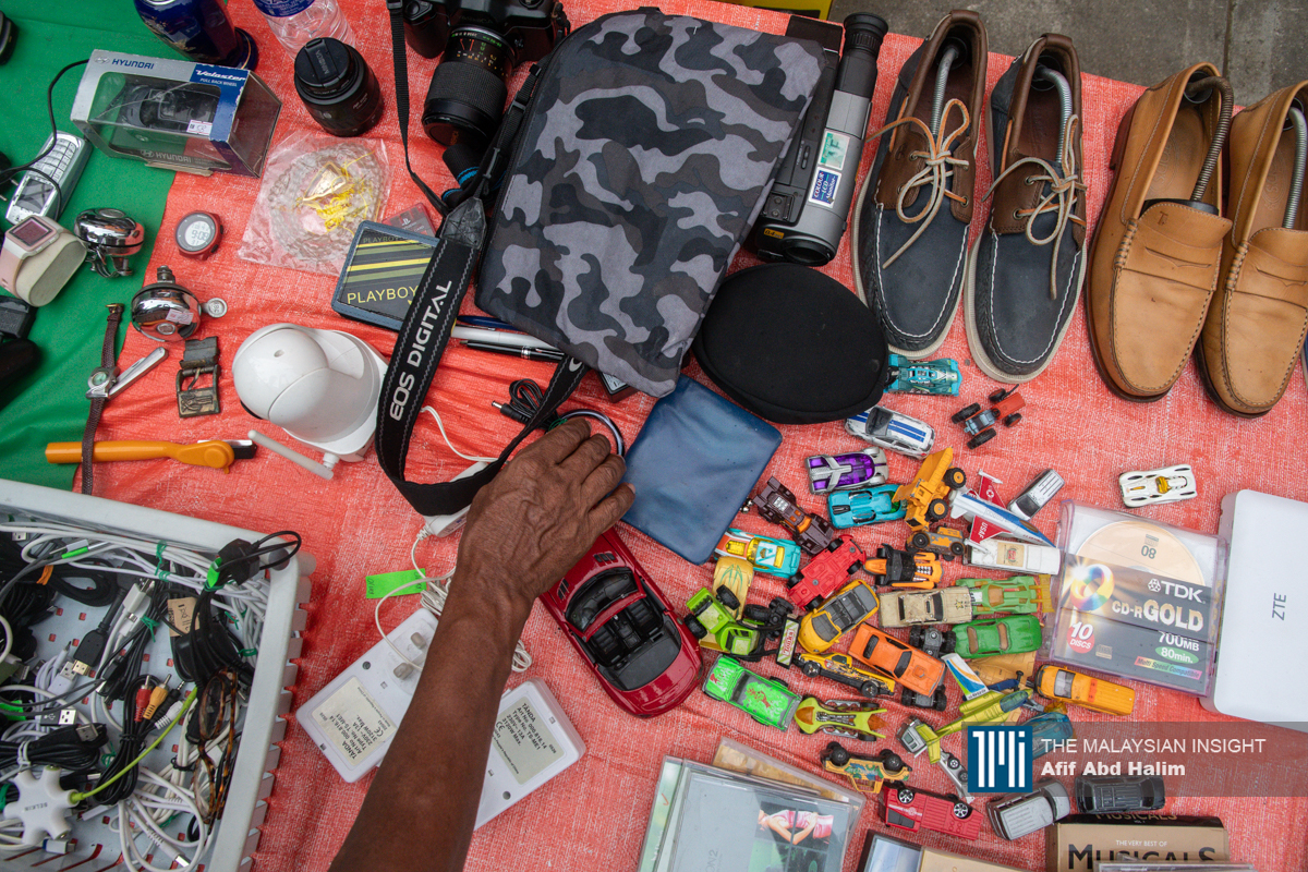 Traders sell used items such as cameras, badminton rackets, toys, shoes and clothing sourced from other fleas markets, jumble sales and secondhand shops. – The Malaysian Insight pic by Afif Abd Halim, April 18, 2024.