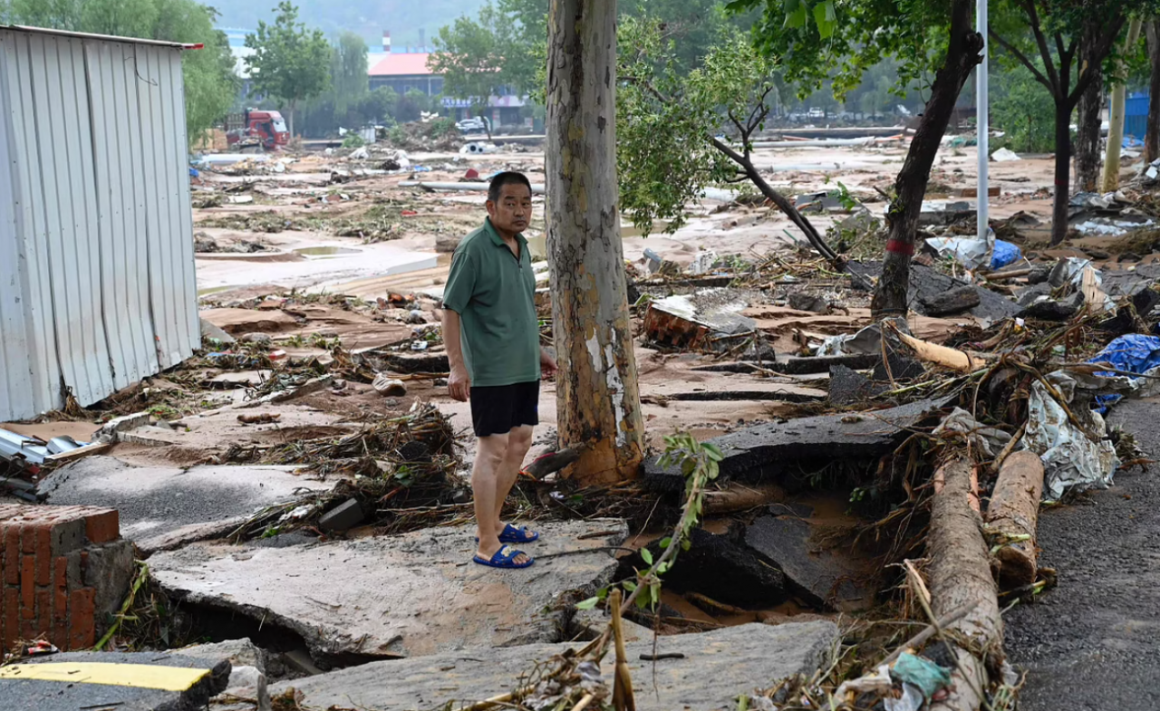 A resident in Gongyi City in Henan, China survey the damage from recent floods that lashed the area. – AFP pic, July 23, 2021