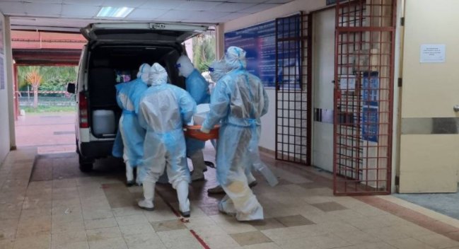 Staff at HTAR moving a body of a patient that died from Covid-19. – Hospital Tengku Ampuan Rahimah Facebook pic, July 17, 2021