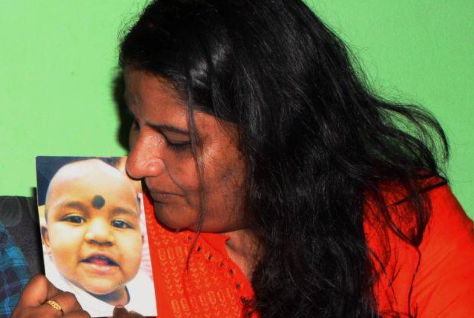 M. Indira Gandhi holds a picture of her daughter, Prasana, who was 11 months old when she last saw her. – File pic, April 21, 2021