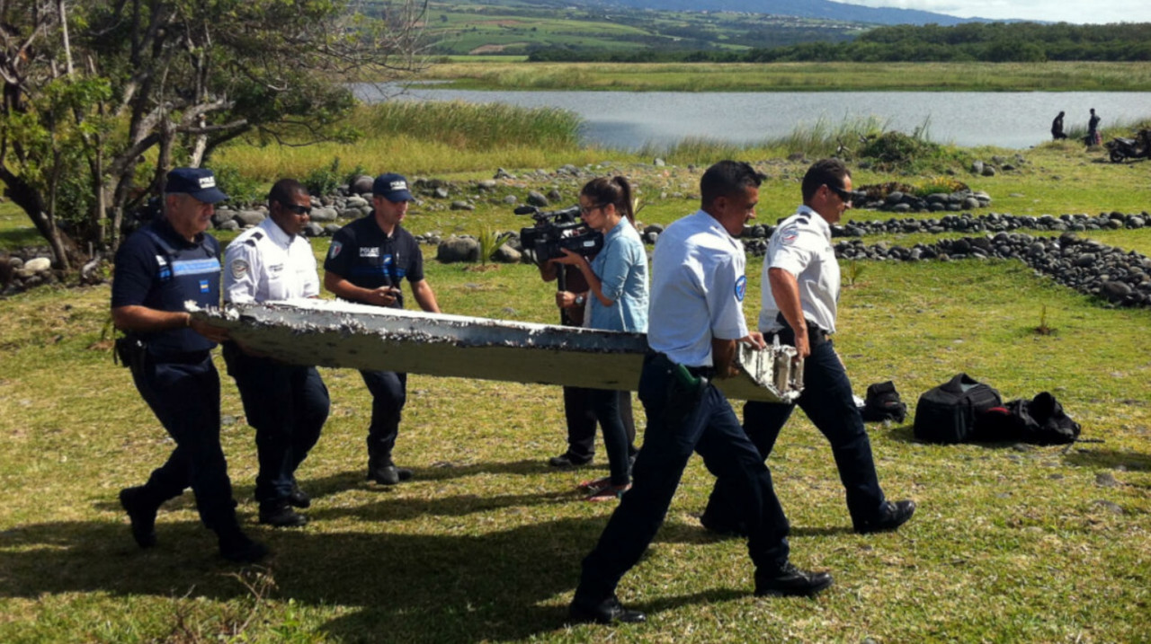 The authorities carrying what is believed to be part of the wreckage of MH370 on Reunion Island in July 29, 2015. – AFP pic, October 3, 2021