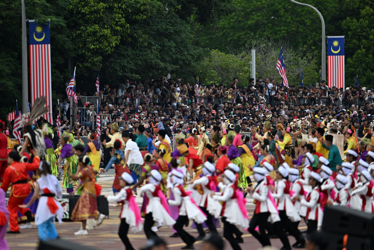 The crowd at Dataran Putrajaya enjoys the colourful parade for National Day. – Information Department pic, August 31, 2023