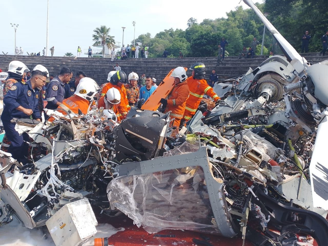 Fire and rescue personnel arrive at the scene of a helicopter crash, near the Royal Malaysian Navy base in Lumut, Perak, today. – Fire and Rescue Department pic, April 23, 2024.
