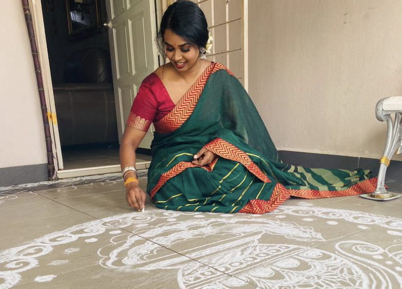 Subitra Ananthan, 29, poses with her kolam. During the festival, she reflects on how much more ‘work’ she had to do for Pongal now as an adult. – KIRTIGHA PANNEE SELVAN/The Vibes pic, January 15, 2023
