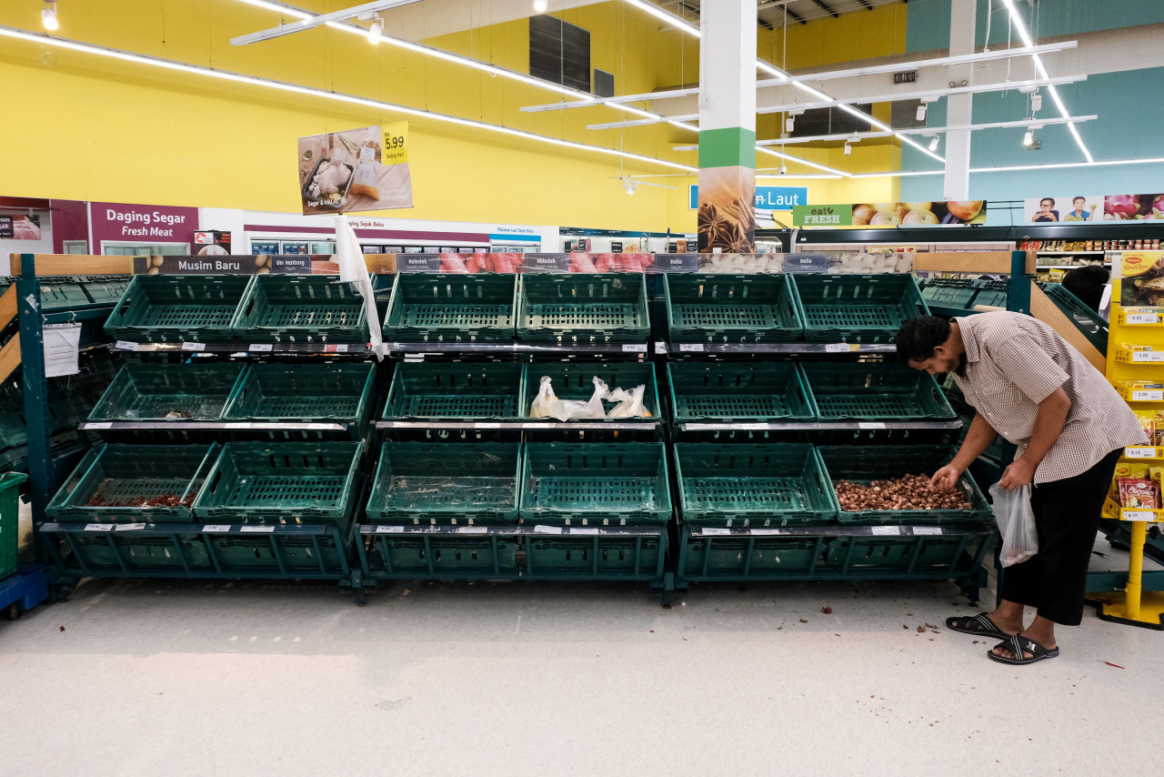 A shopper at a supermarket in Petaling Jaya on March 17, last year, a day before the implementation of the MCO in Malaysia. – AFP pic, March 18, 2021