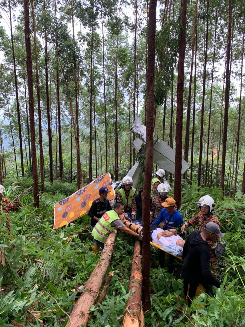 A woman and a male pilot are taken to the hospital for treatment following a plane crash in Sungkai, Perak. – Fire and Rescue Department pic, May 4, 2024.
