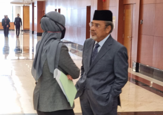A picture of Pasir Salak MP Datuk Seri Tajuddin Abdul Rahman not wearing a mask and another unknow person in the Parliament lobby yesterday. – @sultanoftasik Twitter pic, July 27, 2021