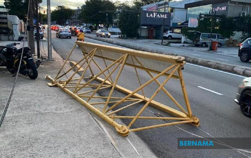 Woman cheats death after part of tower crane falls on car