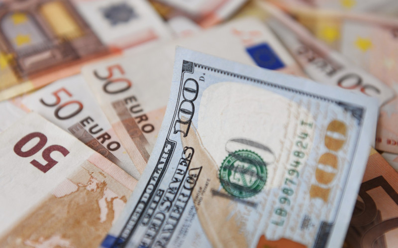 Global stocks tumble while euro dips below US dollar for first time in 20 years